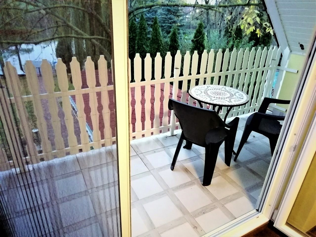 The balcony with table and chairs, looking over the garden