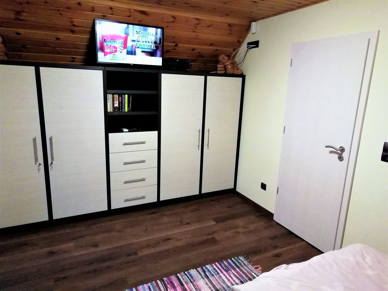The wardrobe wall in the bedroom, with a television