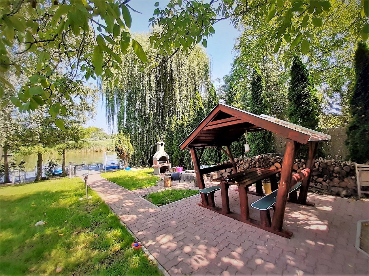 The covered garden table beside the firewood