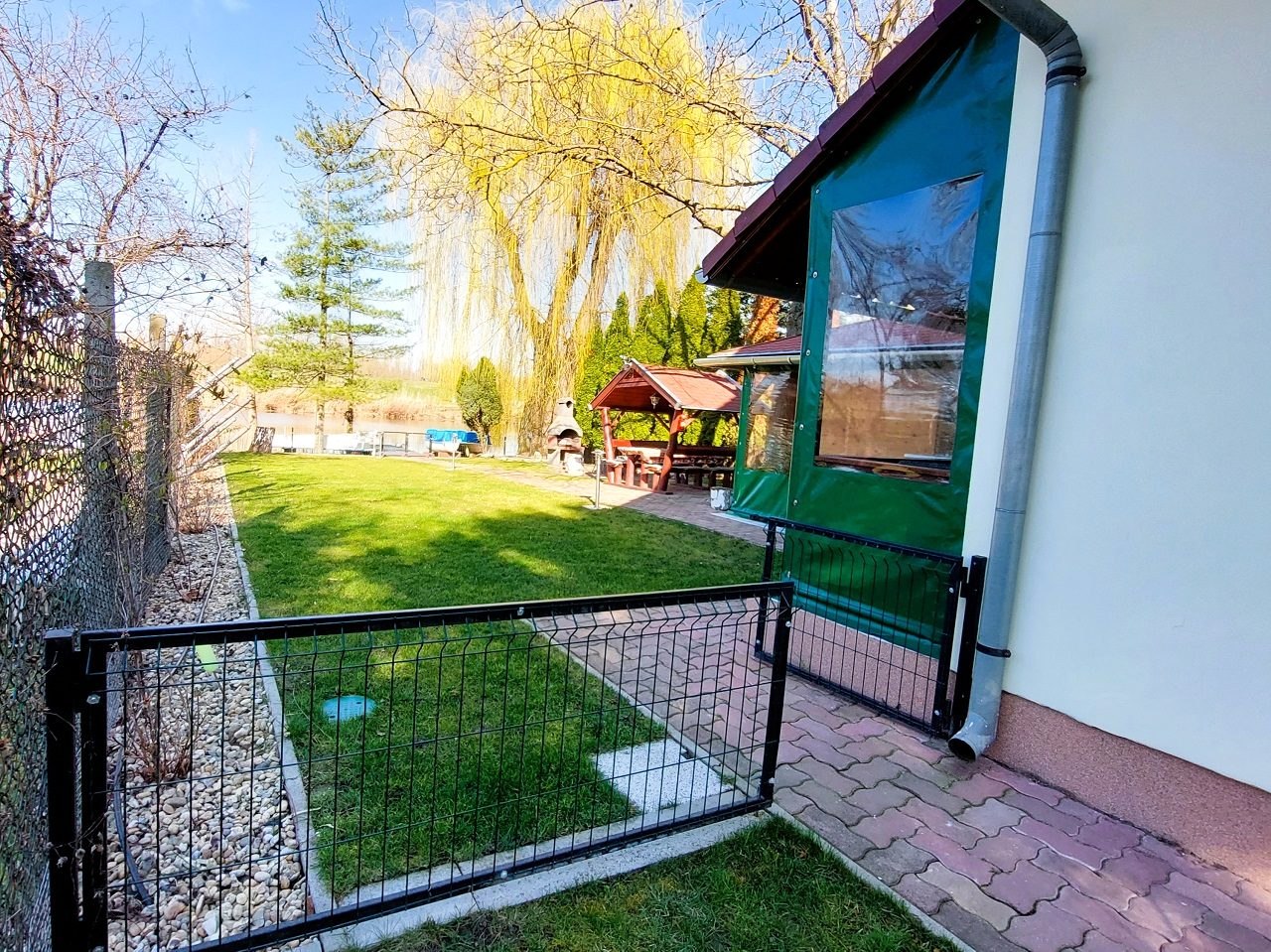 The gate and the fence from the street, beside the house