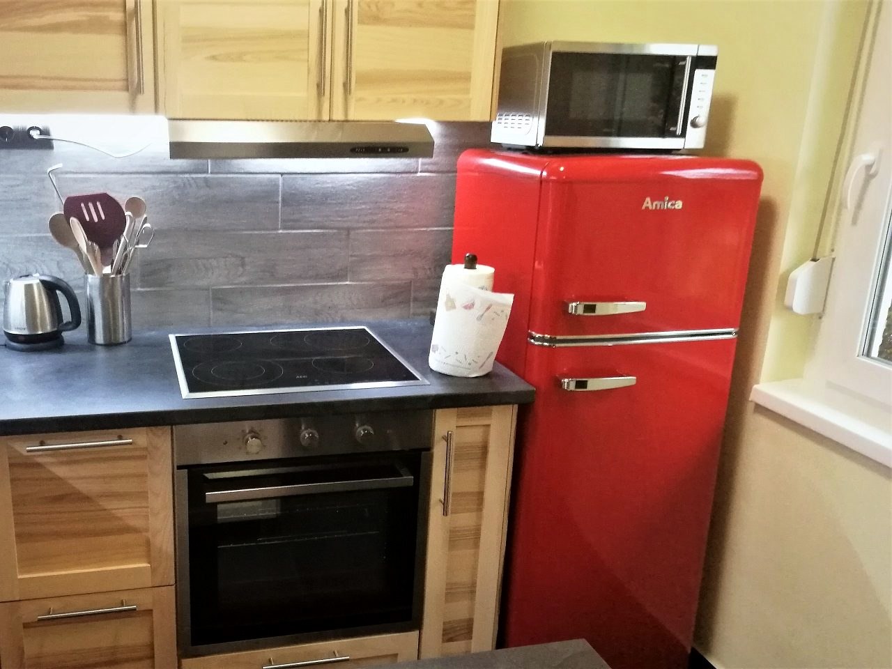 The kitchen with the fridge and the microwave