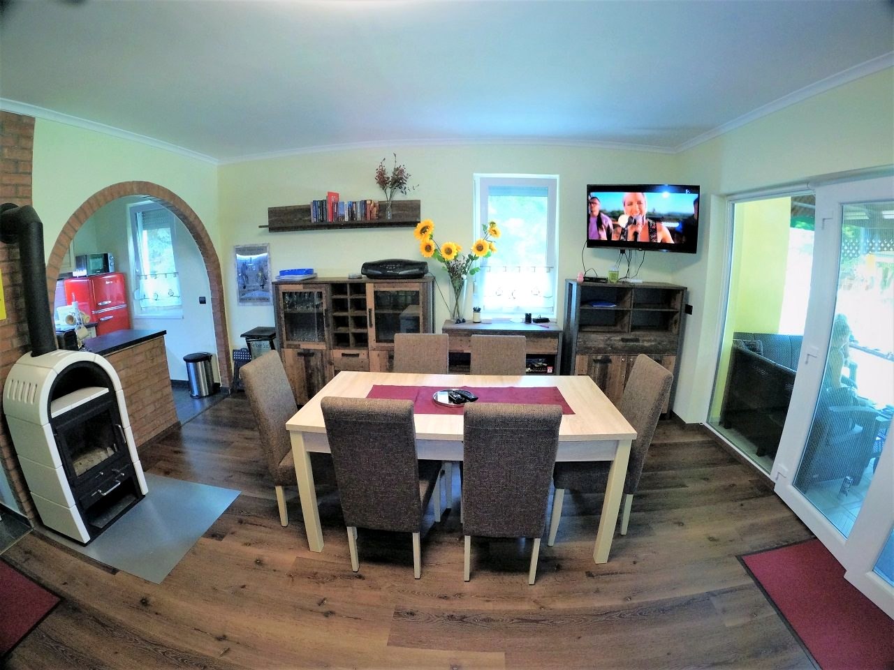 The dining area with a large table, opening off the living room
