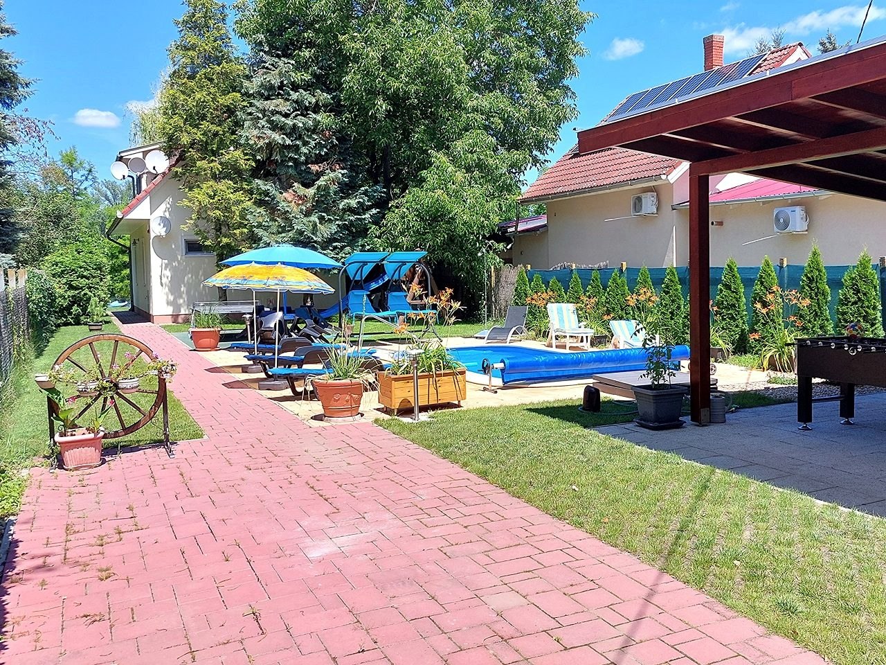The pool and the covered seating area on the paved section