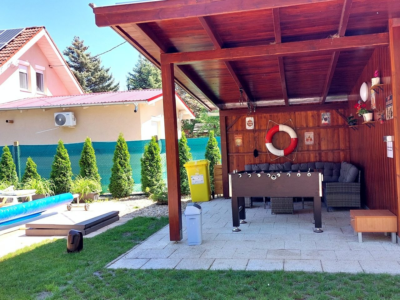 The covered seating area with table football and a sofa set