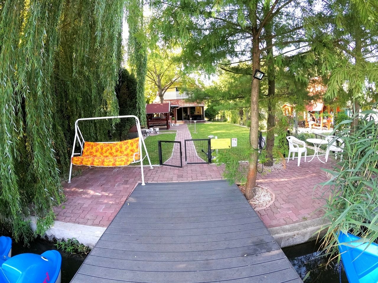 The bank at the end of the garden, with benches facing the water